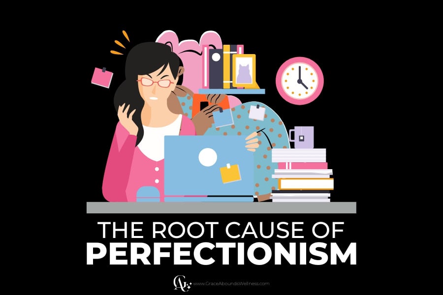 root cause of perfectionism - a busy and stressed woman sitting at a desk